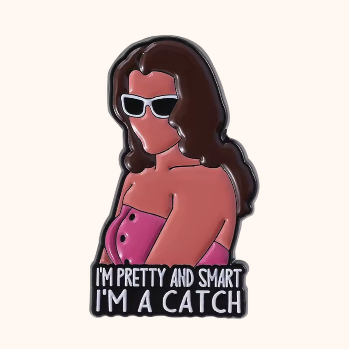 An enamel pin featuring a SATC-inspired Charlotte York with brown hair, white sunglasses, and a pink top, with the text 'I'M PRETTY AND SMART I'M A CATCH' at the bottom.