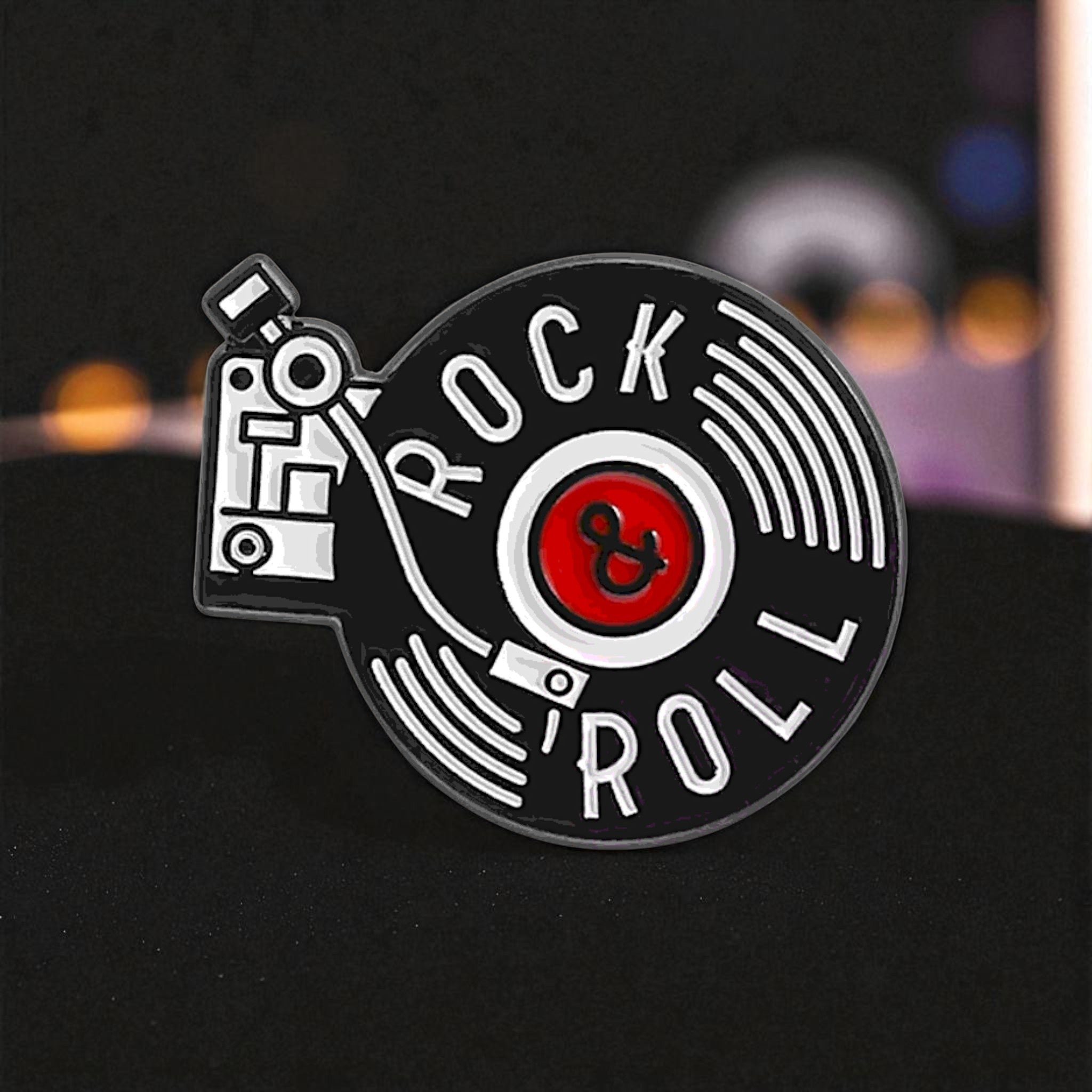 Pin with 'Rock & Roll' design on a black background