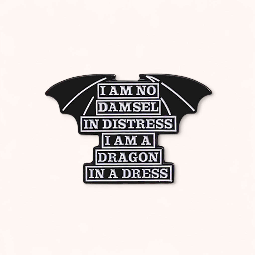 Black bat-shaped enamel pin with text on a white background